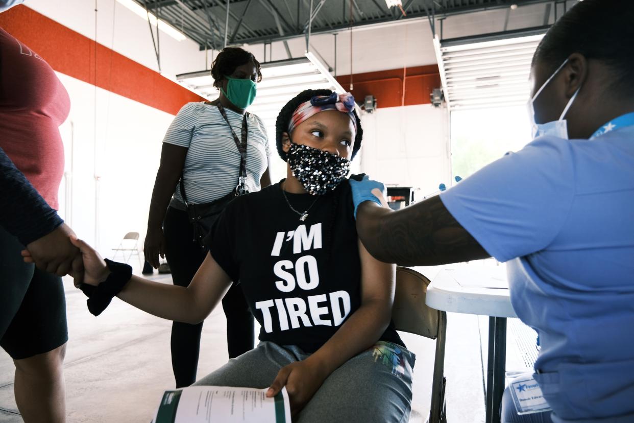 Twelve-year-old child receives a COVID vaccine in Ferguson, Missouri. 