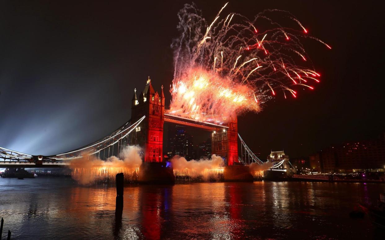 A light display over the Thames and fireworks on Tower Bridge in London - Jonathan Brady/PA 