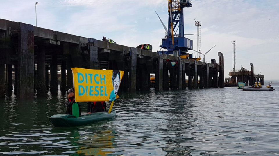 <em>Protestors hung up a huge ‘ditch diesel’ sign at the port (Greenpeace)</em>