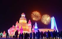 <p>Visitors watch fireworks atthe opening ceremony of the Harbin International Ice and Snow Festival in China.</p>