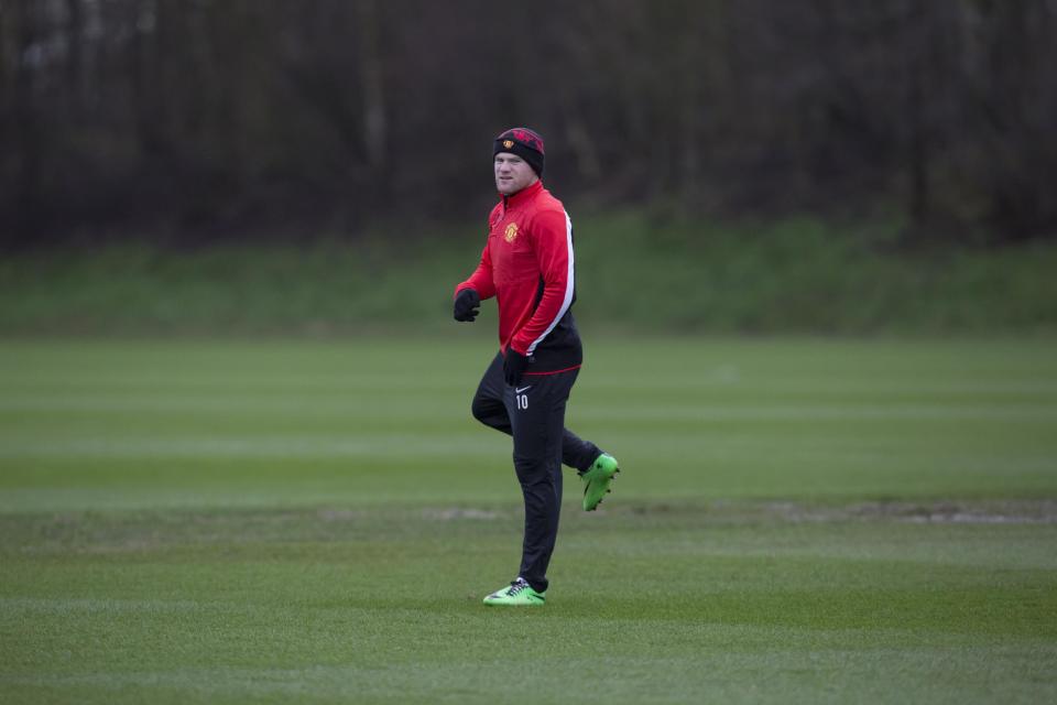 Manchester United's Wayne Rooney trains with teammates at Carrington training ground in Manchester, Monday, Feb. 24, 2014. Manchester United will play Olympiakos in a Champions League first knockout round on Tuesday. (AP Photo/Jon Super)