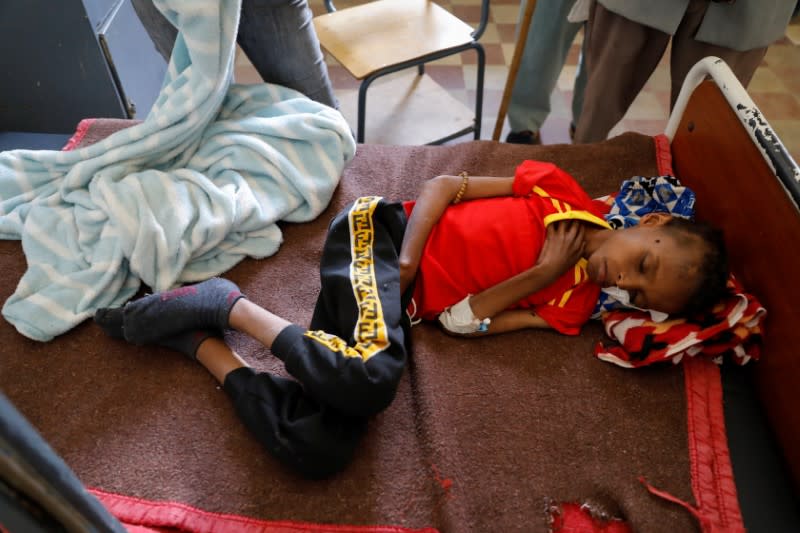 Fourteen-year-old Adan Muez lies in a bed at Adigrat General Hospital in the town of Adigrat, Tigray region
