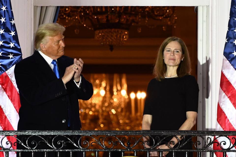 President Donald Trump applauds Judge Amy Coney Barrett after she was sworn in as a Supreme Court Associate Justice during a ceremony on the South Lawn of the White House on October 26, 2020.