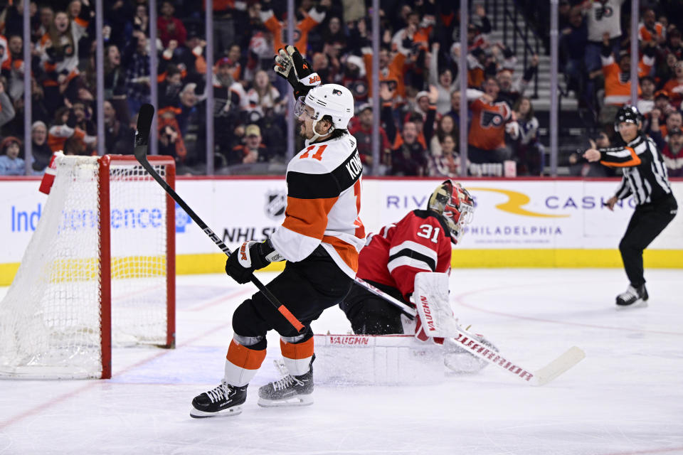 Philadelphia Flyers' Travis Konecny, left, celebrates after scoring past New Jersey Devils goaltender Kaapo Kahkonen (31) during the second period of an NHL hockey game, Saturday, April 13, 2024, in Philadelphia. (AP Photo/Derik Hamilton)