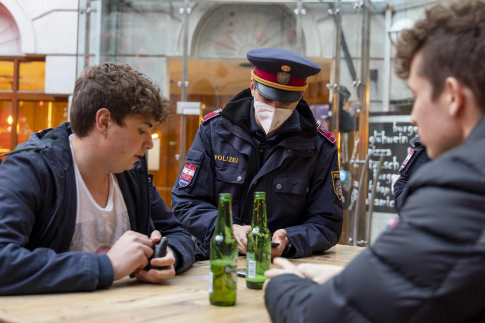 Police officers monitor compliance after introducing a lockdown for the unvaccinated. Source: Getty 