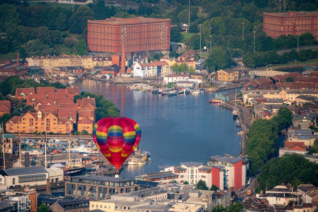 A hot air balloon takes to the sky over Bristol Harbour (Ben Birchall/PA)