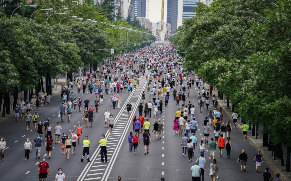 Pedestrians and runners travel along the pedestrianized zone of the Paseo de la Castellana road - Bloomberg