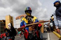 <p>An opposition supporter shows a sling shot built to resemble a gun during a rally against President Nicolas Maduro in Caracas, Venezuela, May 15, 2017. (Carlos Garcia Rawlins/Reuters) </p>