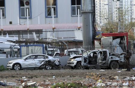 A member of the police special forces stands next to vehicles, which were damaged by a car bomb attack that targeted a minibus (not pictured) carrying members of the police special forces, occurred in the Kurdish-dominated southeastern city of Diyarbakir, Turkey March 31, 2016. REUTERS/Stringer/Files