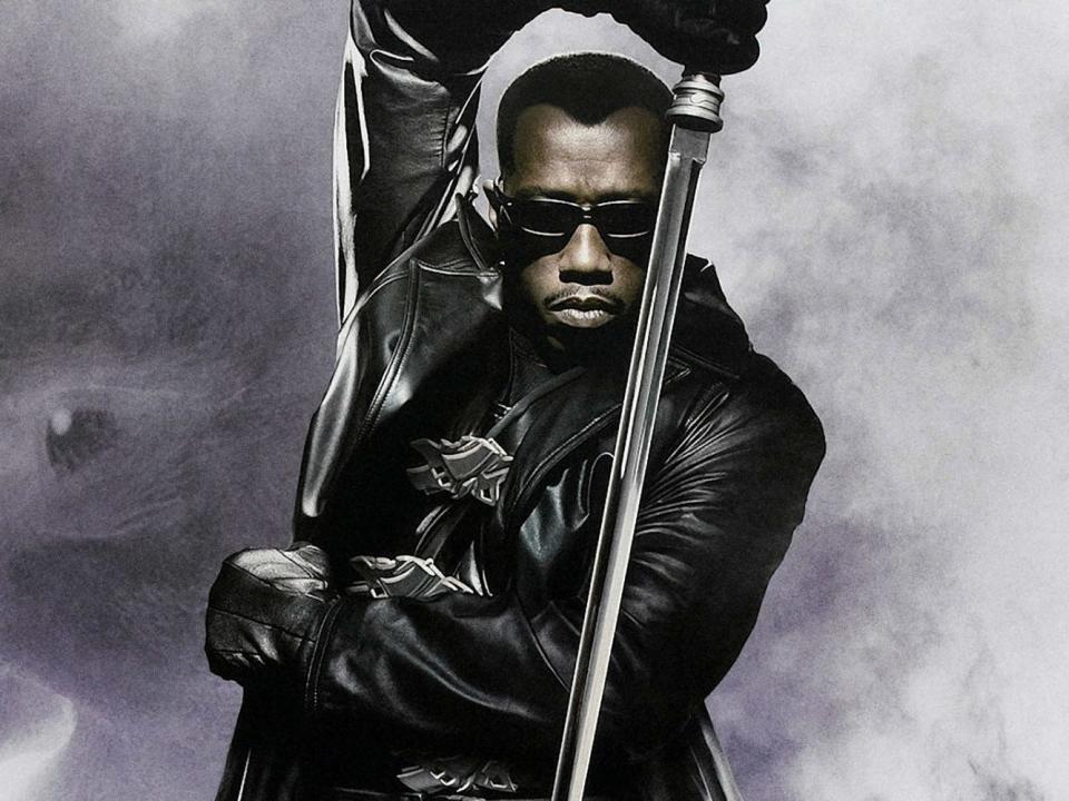 Blade in a black jacked and holding a sword