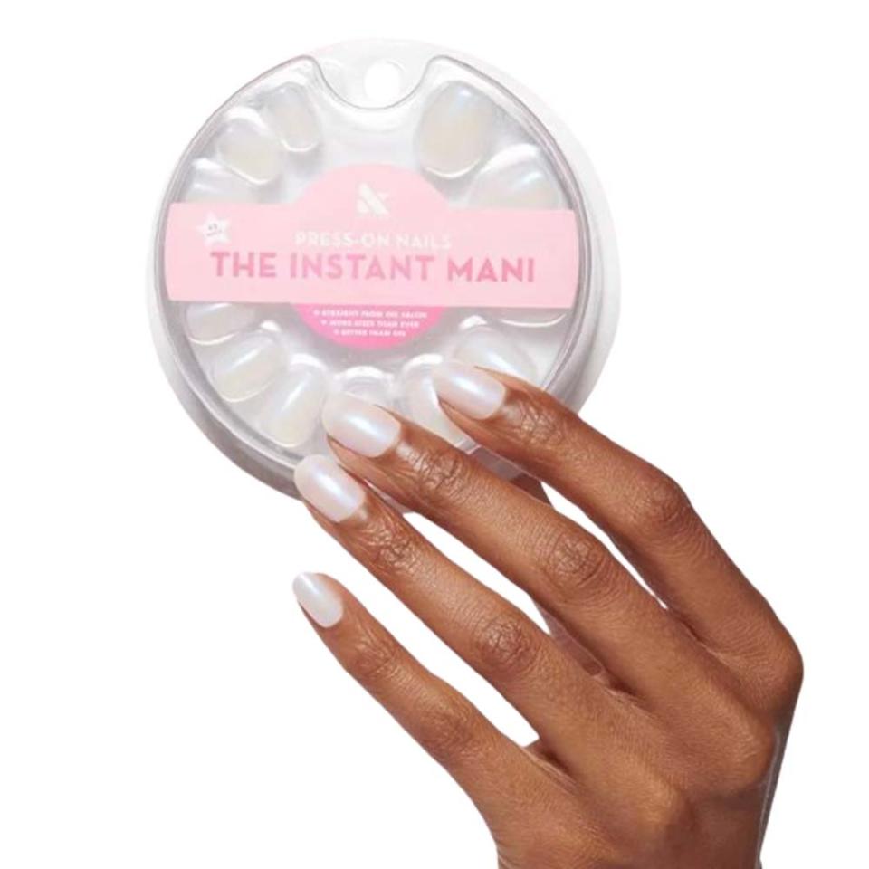 hand holding white press-on nail kit