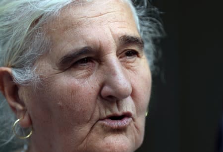 A member of "Mothers of Srebrenica" association talks with the media as she waits for the ruling on the case brought by relatives of the victims of the 1995 Srebrenica massacre, at the Dutch high court in The Hague