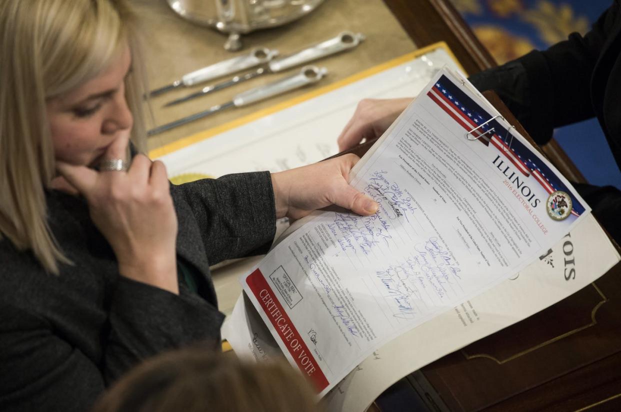 <span class="caption">Staff of the House of Representatives review Illinois' Electoral College vote report in January 2017.</span> <span class="attribution"><a class="link " href="https://www.gettyimages.com/detail/news-photo/house-clerk-staff-verify-the-official-electoral-college-news-photo/631100318" rel="nofollow noopener" target="_blank" data-ylk="slk:Samuel Corum/Anadolu Agency/Getty Images;elm:context_link;itc:0;sec:content-canvas">Samuel Corum/Anadolu Agency/Getty Images</a></span>