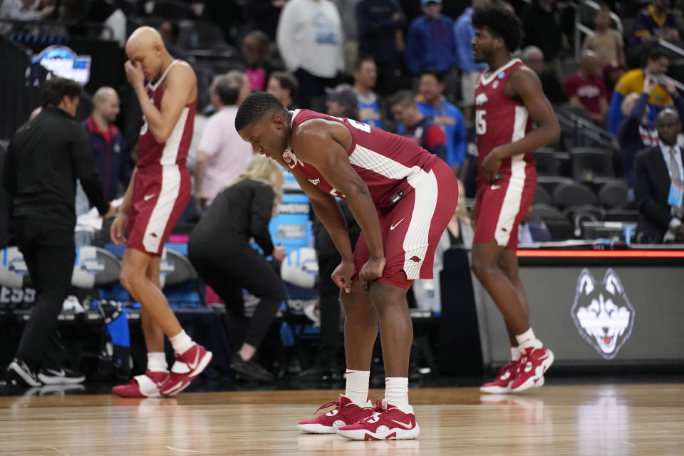 Arkansas' Derrian Ford, middle, reacts after the 88-65 loss to UConn of a Sweet 16 college basketball game in the West Regional of the NCAA Tournament, Thursday, March 23, 2023, in Las Vegas. (AP Photo/John Locher)