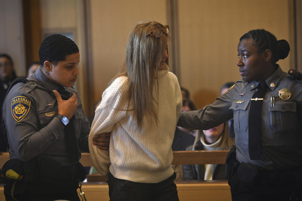 Court marshals lead Michelle Troconis out of the courtroom at Connecticut Superior Court in Stamford, Conn. Friday, March 1, 2024. Troconis was found guilty by the jury following a lengthy trial in which prosecutors laid out a case that she helped her then-boyfriend, Fotis Dolus, plot and cover up the killing of his estranged wife, Jennifer Dulos, as they battled each other in divorce and child custody proceedings. (Ned Gerard/Hearst Connecticut Media via AP, Pool)