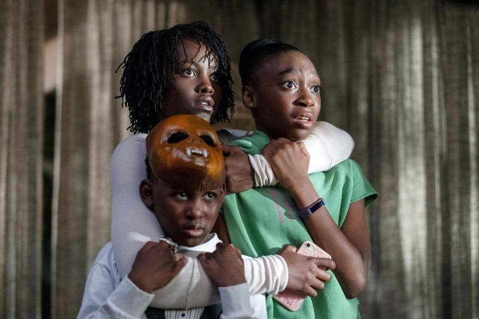 three young people hugging each other in fear