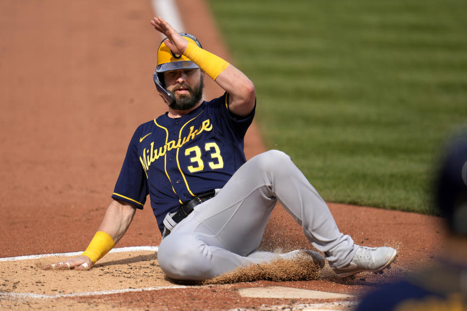 Milwaukee Brewers' Jesse Winker (33) scores from third on a groundout by Rowdy Tellez off Pittsburgh Pirates starting pitcher Johan Oviedo during the second inning of a baseball game in Pittsburgh, Saturday, July 1, 2023. (AP Photo/Gene J. Puskar)