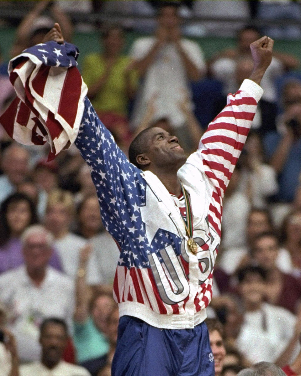 FILE - In this Aug. 8, 1992, file photo, USA's Earvin "Magic" Johnson rejoices with his gold medal after beating Croatia 117-85 in the gold medal game in men's basketball at the Summer Olympics in Barcelona. (AP Photo/Susan Ragan, File)