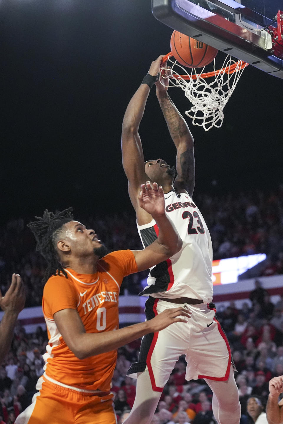 Georgia forward Jalen DeLoach (23) is unable to score as Tennessee forward Jonas Aidoo (0) defends during the second half of an NCAA college basketball game Saturday, Jan. 13, 2024, in Athens, Ga. (AP Photo/John Bazemore)