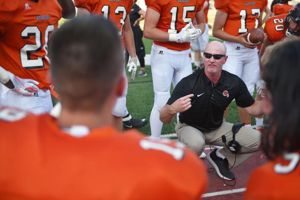 Washington's head coach 	Chad Stadem talks to the players on the sidelines during the game against Mitchell Friday, Sept.14, at Howard Wood Field.