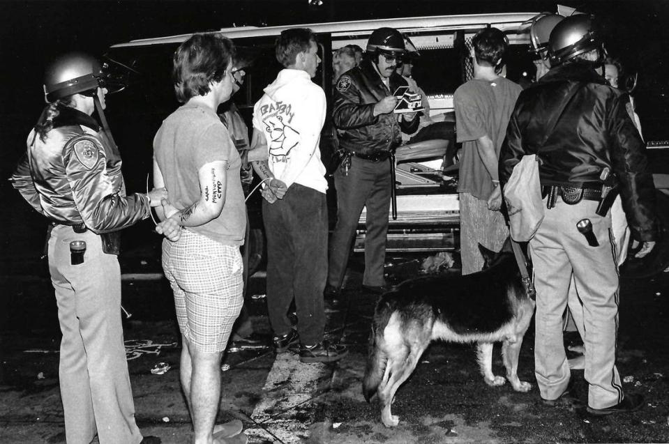Arrested people are photographed and loaded into a sheriff’s van about 2:30 a.m. Sunday during the Poly Royal riots of 1990.