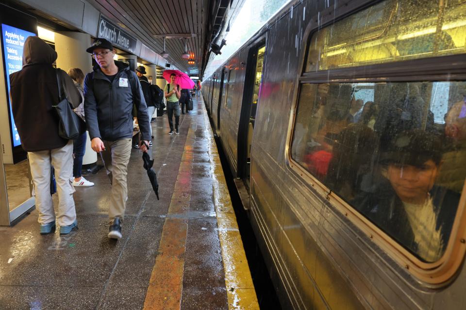 People stand around at the Church Avenue subway station as subway service is stopped amid heavy rain on Sept. 29, 2023 in the Flatbush neighborhood of Brooklyn borough New York City. Flash flooding is expected in the counties of Nassau, Queens and Kings, which includes Brooklyn, according to the state’s National Weather Service office as remnants of Tropical Storm Ophelia reaches the Northeast.