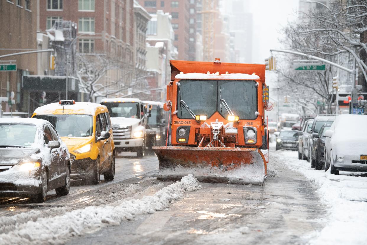 A snow plow clears Third Ave. in Manhattan on Friday, Jan. 7, 2022. 