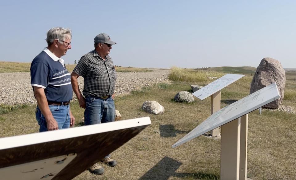 David and Dyce Bolduc stand next to the Pine Coulee off-stream reservoir west of Stavely, Alta. The two brothers run a large farm and beef operation in the MD of Willow Creek.
