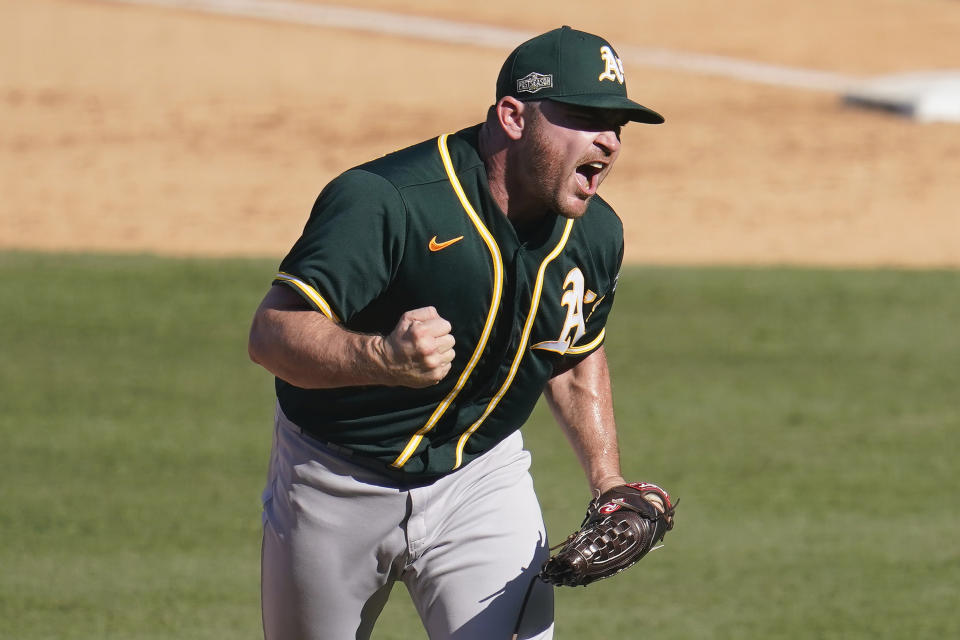 FILE - Oakland Athletics pitcher Liam Hendriks reacts after striking out Houston Astros' Josh Reddick during the eighth inning of Game 3 of a baseball American League Division Series in Los Angeles, in this Wednesday, Oct. 7, 2020, file photo. The Chicago White Sox have finalized a $54 million, three-year deal with Oakland Athletics closer Liam Hendriks, another big move as they set their sights on a championship run. The deal was announced Friday, Jan. 15, 2021. (AP Photo/Marcio Jose Sanchez)