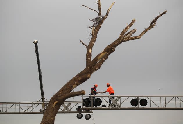 Kansas City Southern workers repair a broken railroad signal after a massive tornado passed through the town killing at least 123 people on May 25, 2011, in Joplin, Missouri. (Photo: Mario Tama via Getty Images)