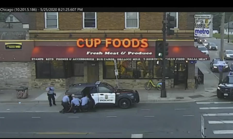 In this image from Minneapolis city surveillance video, Minneapolis police are seen attempting to take George Floyd into custody May 25, 2020, in Minneapolis, Minn. The video was shown as Hennepin County Judge Peter Cahill presides Monday, March 29, 2021, in the trial of former Minneapolis police officer Derek Chauvin, in the death of George Floyd at the Hennepin County Courthouse in Minneapolis, Minn. (Court TV via AP, Pool)