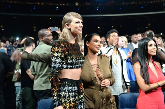 Taylor Swift stands with Kim Kardashian in embellished outfits at an event