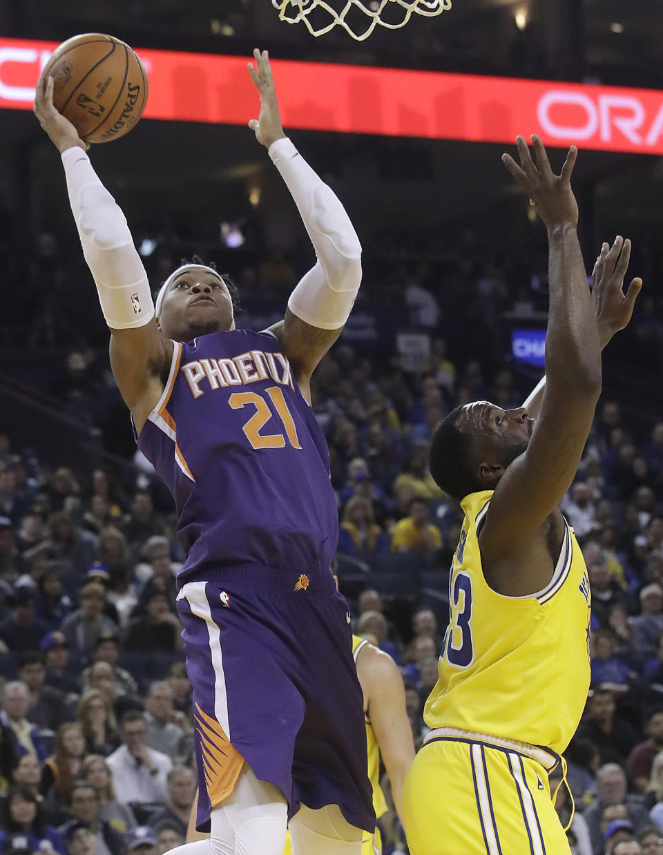 Phoenix Suns forward Richaun Holmes, left, shoots against Golden State Warriors forward Draymond Green, right, during the first half of an NBA basketball game in Oakland, Calif., Sunday, March 10, 2019. (AP Photo/Jeff Chiu)