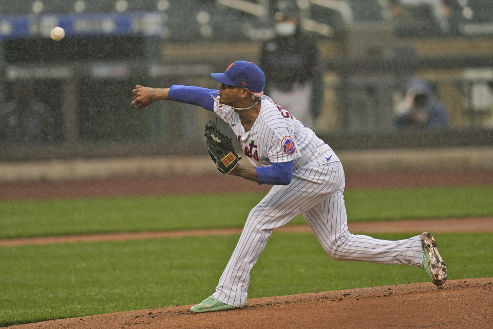 New York Mets starting pitcher Marcus Stroman throws in the rain against the Miami Marlins during the first inning of a baseball game at Citi Field, Sunday, April 11, 2021, in New York. The game was delayed at the top of the first inning due to rain. (AP Photo/Seth Wenig)