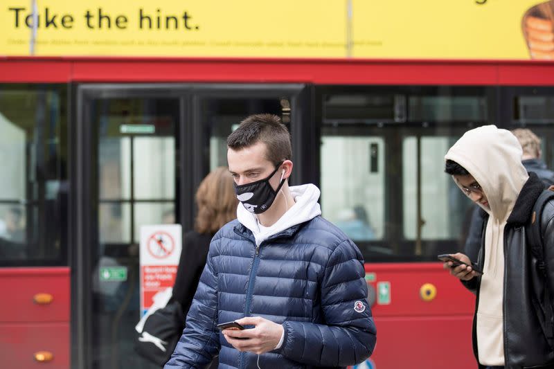 A man wears a protective mask as he walks on Oxford Street in London