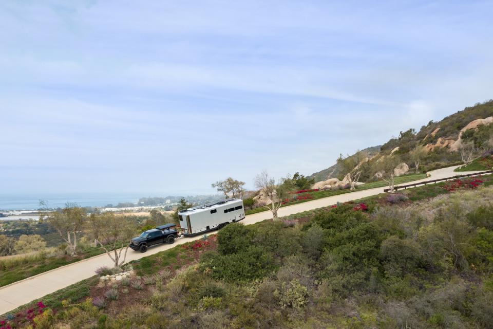 Living Vehicle, luxury RV with man and woman modeling how to use spaces