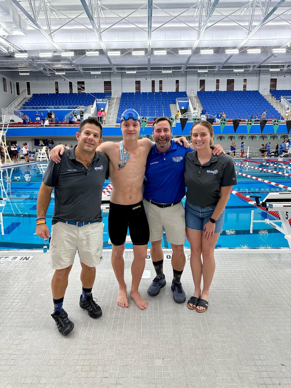 (From Left to Right) Booker T. Washington head coach Whitney Voeltz, senior Logan Robinson, assistants Chris Barfield and Audrey Stein celebrate after Robinson won three state titles during the Class 3A State Championship on Saturday, Nov. 11, 2023 in Ocala.