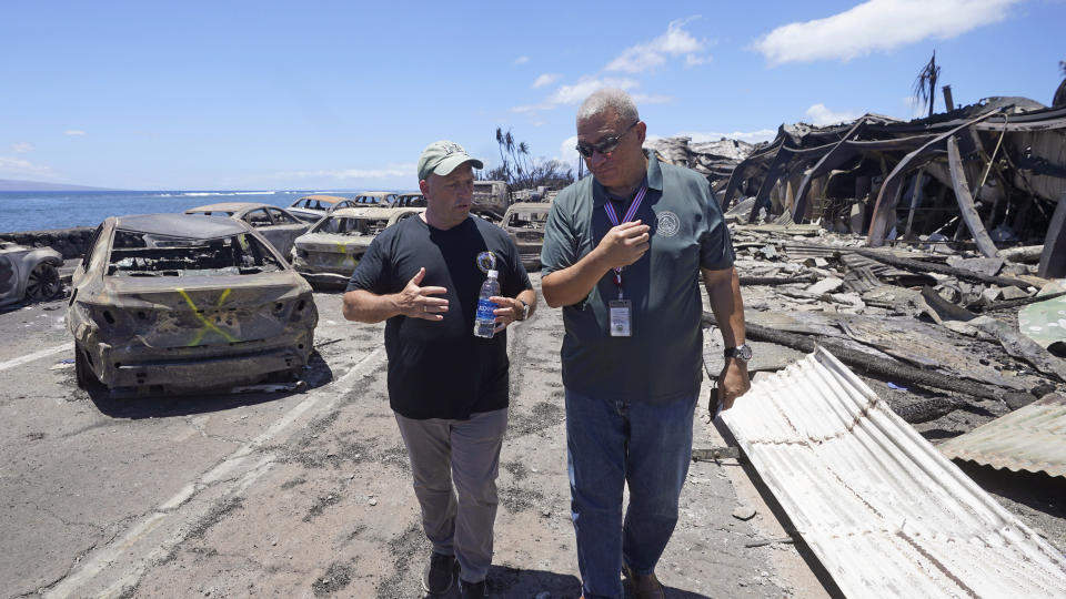 Hawaii Gov. Josh Green, left, and Maui County Mayor Richard Bissen, Jr., speak during a tour of wildfire damage on Saturday, Aug. 12, 2023, in Lahaina, Hawaii. (AP Photo/Rick Bowmer)