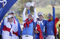 Team Europe's Suzann Pettersen, center, celebrates with her team and the trophy following Team Europe's victory in the Solheim Cup against the US at Gleneagles, Auchterarder, Scotland, Sunday, Sept. 15, 2019. (Ian Rutherford/PA via AP)