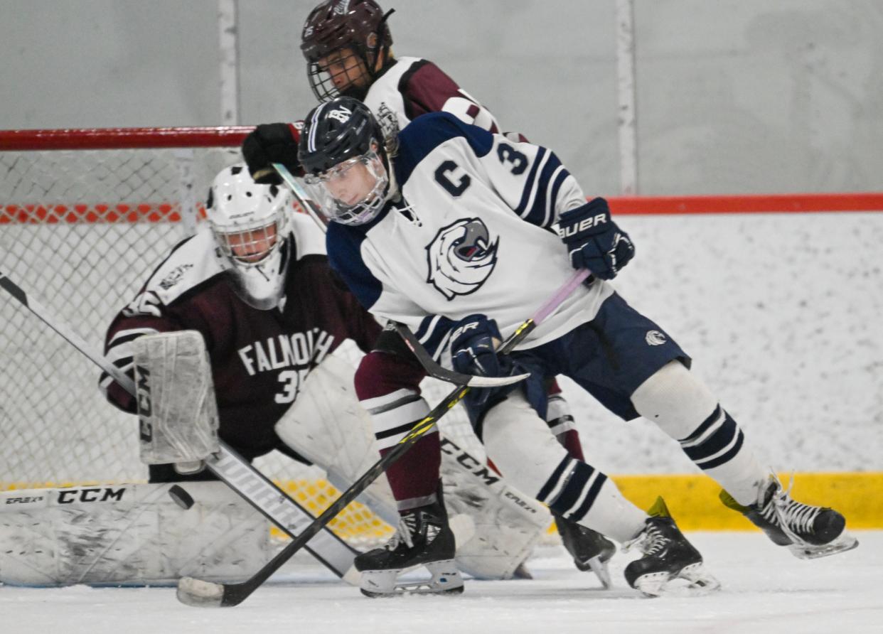 Falmouth goalie Eddie Leary stops a shot by Sean Hallissey of Plymouth North. Falmouth lost 2-1 and ended its playoff run.