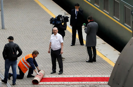 A worker removes the red carpet after North Korean leader Kim Jong Un's arrival at the railway station in the Russian far-eastern city of Vladivostok, Russia, April 24, 2019. REUTERS/Shamil Zhumatov