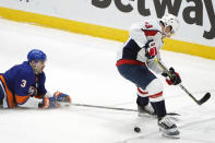 New York Islanders defenseman Adam Pelech (3) tries to prevent Washington Capitals left wing Conor Sheary (73) from getting to the puck during the second period of an NHL hockey game Thursday, April 22, 2021, in Uniondale, N.Y. (AP Photo/Kathy Willens)