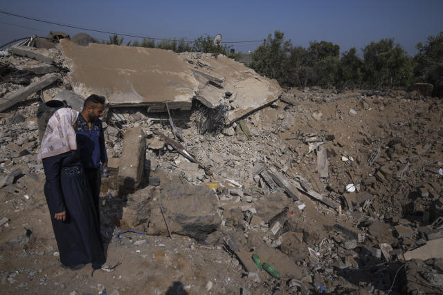 Palestinians inspect the rubble of a house after it was struck by an Israeli airstrike in Khan Younis, southern Gaza Strip, Thursday, May 11, 2023. Early on Thursday, the Israeli military killed Ali Ghali, a senior Islamic Jihad commander said to be in charge of the group's rocket force, when it struck his home as part of strikes against the Islamic Jihad militant group. (AP Photo/Fatima Shbair)