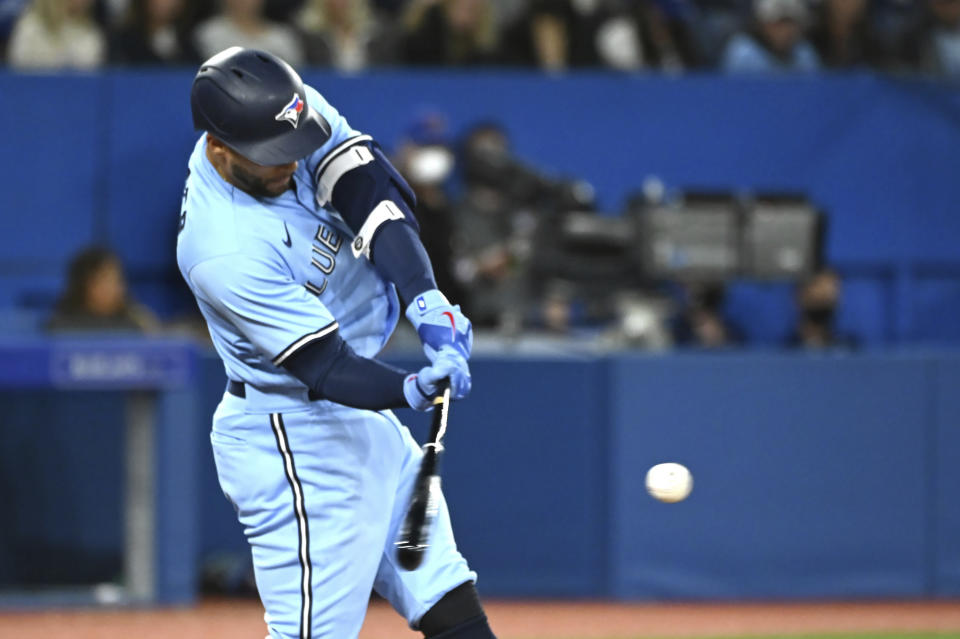 Toronto Blue Jays' Kevin George Springer hits a single during the fifth inning of a baseball game against the Seattle Mariners in Toronto on Wednesday, May 18, 2022. (Jon Blacker/The Canadian Press via AP)