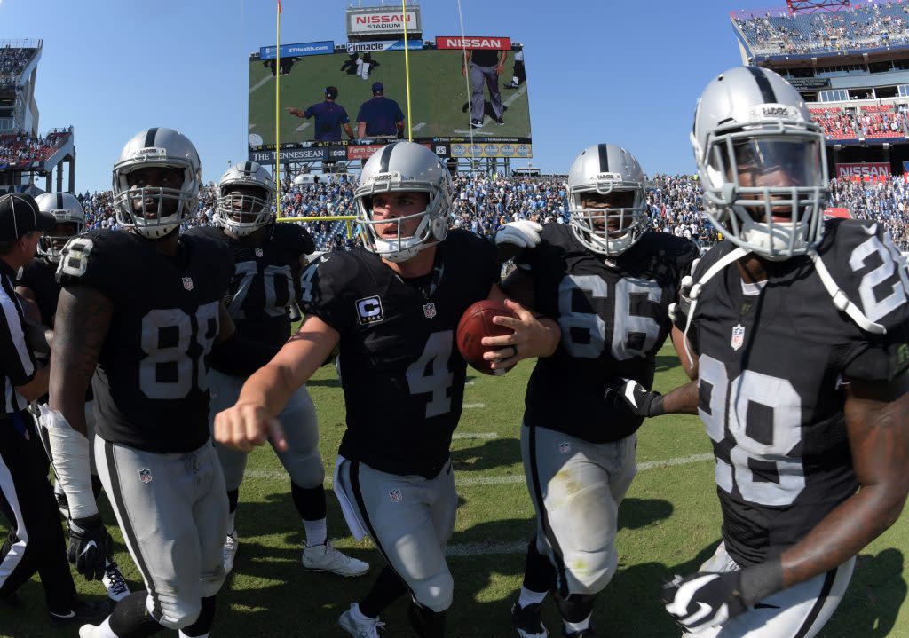 Sep 25, 2016; Nashville, TN, USA; Oakland Raiders players Clive Walford (88), Kelechi Osemele (70), Derek Carr (4), Gabe Jackson (66) and Latavius Murray (28) celebrate after defeating the Tennessee Titans 17-10 at Nissan Stadium. Mandatory Credit: Kirby Lee-USA TODAY Sports