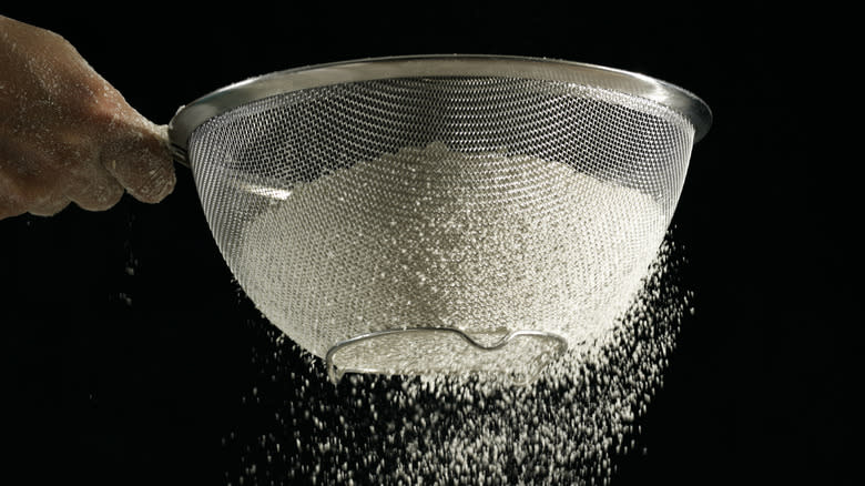 Sifting flour with sifter