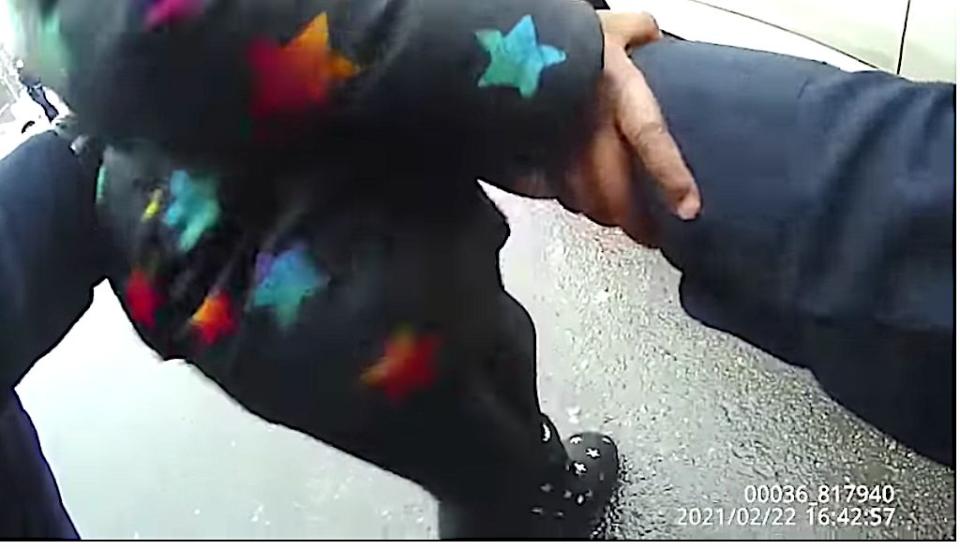 Police restrain the 3-year-old girl from running to her mom. (Photo: Screen Shot/Rochester Police Body Cam Video/Rochester Police Department)