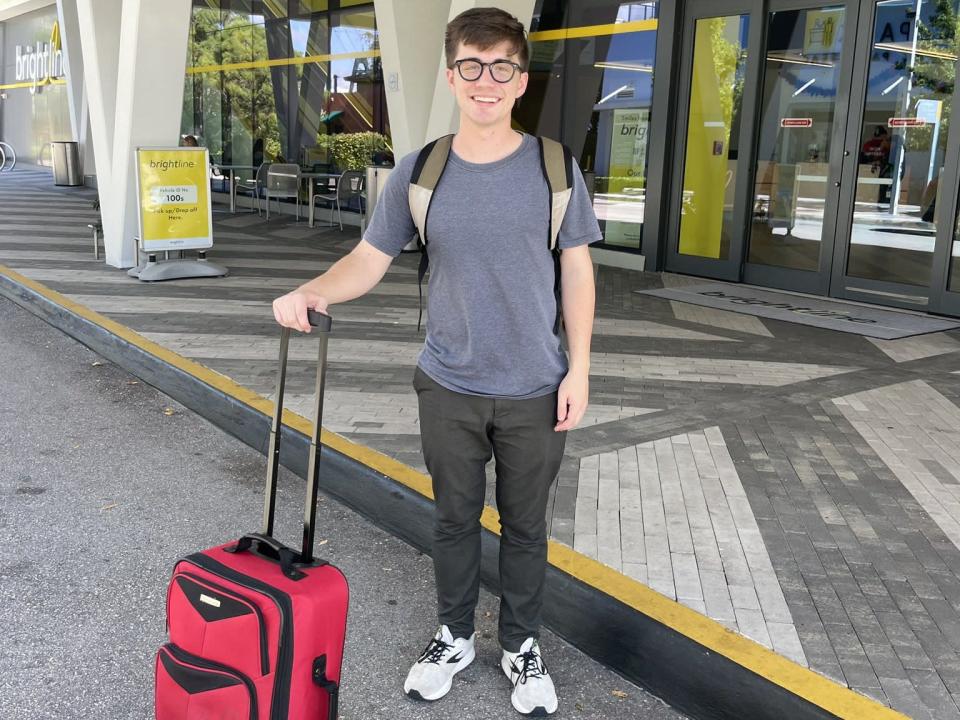 Lukas Flippo standing with suitcase