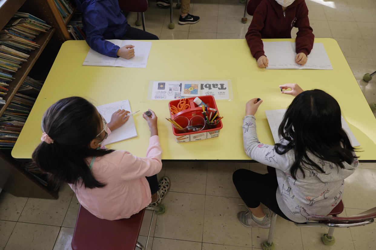 Masked students participate in a lesson in their classroom at Yung Wing School in New York City.