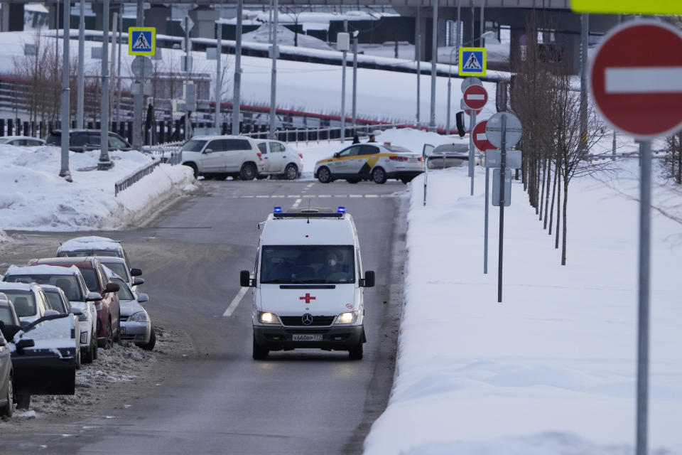 An ambulance approaches a COVID-19 hospital in Kommunarka, outside Moscow, Russia, Thursday, Jan. 27, 2022. Russia's state coronavirus task force has reported more than 11.3 million confirmed cases and over 328 thousands deaths, by far the largest death toll in Europe. (AP Photo/Pavel Golovkin)